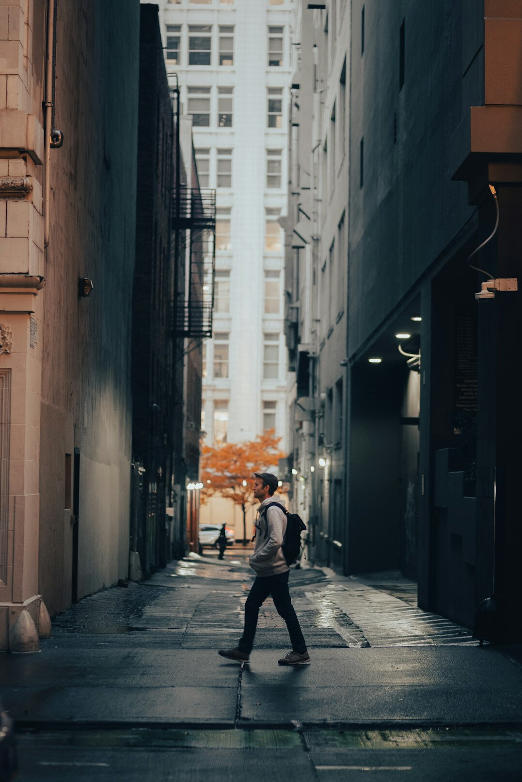 Photographer walking through a city street with a camera