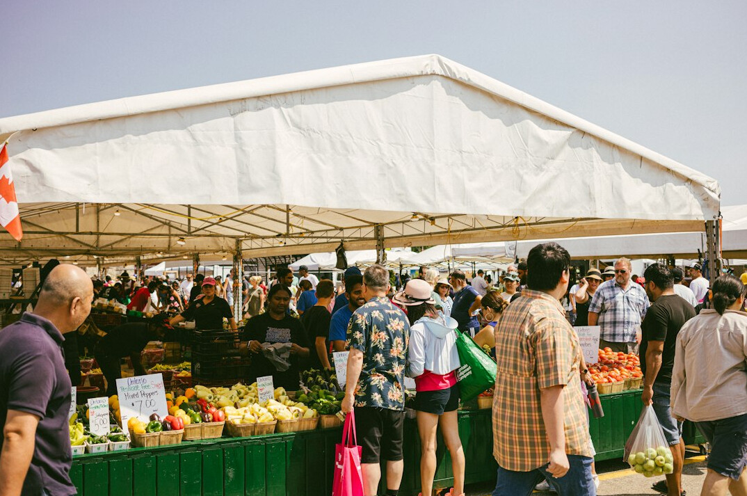 People queuing at an outdoor market stall in Chile